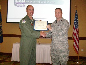 In October, Lt. Col. Keith Perkins, USAF (r), chapter president, presents a token of appreciation to Col. Michael Gantt, USAF, commander of the 53rd Wing.